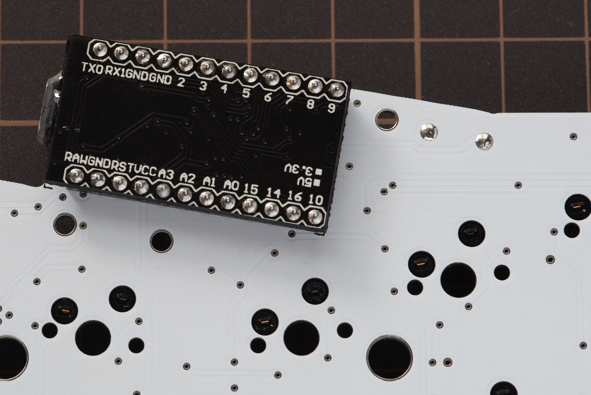 Tactile reset switch soldered to the back of the PCB