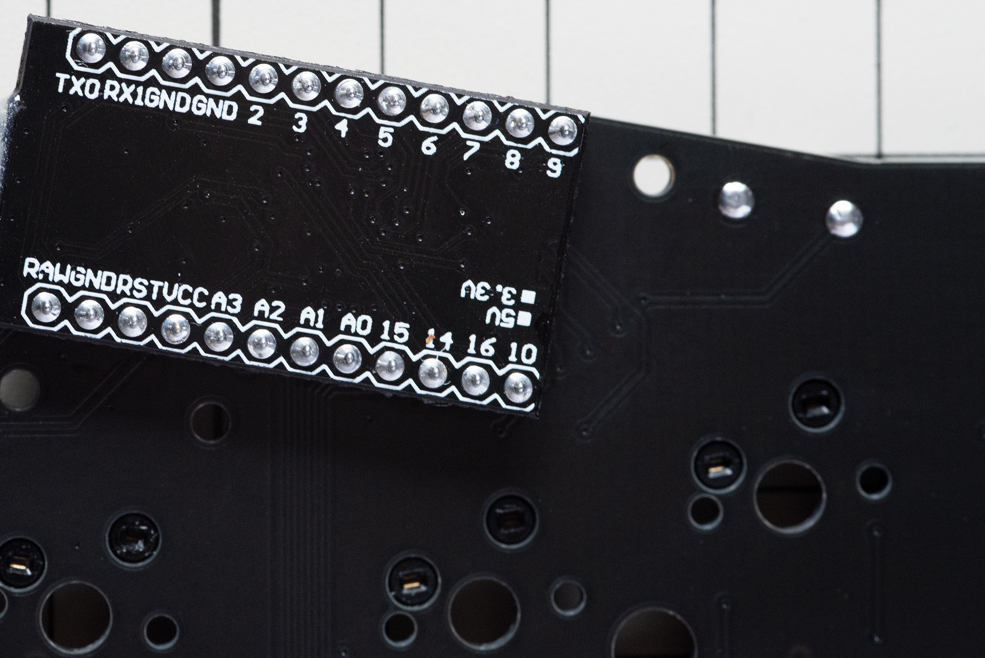 Tactile reset switch soldered to the back of the PCB